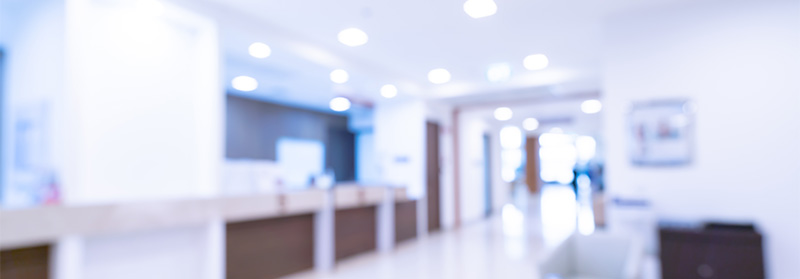 A blurred out view of a pristine white medical waiting room.