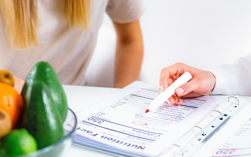 Two people look through a nutrition chart together.