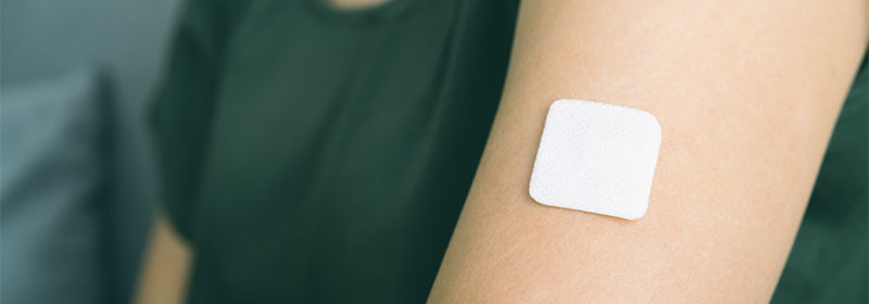 A nicotine patch on a woman's arm
