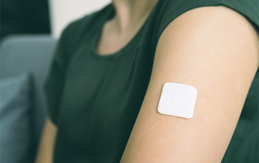 A nicotine patch on a woman's arm